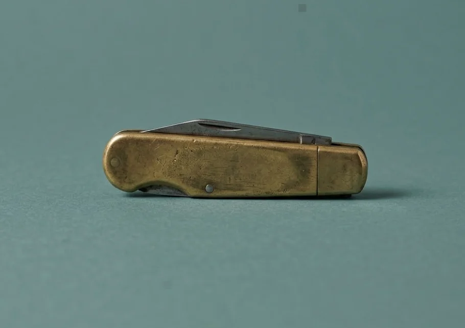 A closed brass pocket knife